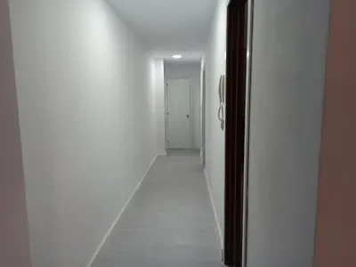 a hallway with white walls and a long corridor at Viña 41 in Cádiz