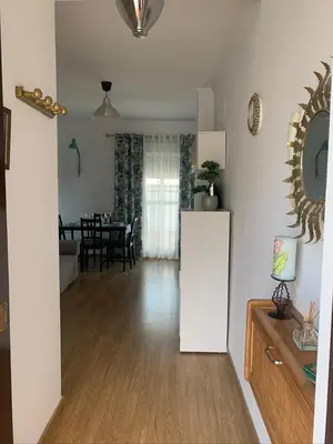 a living room with a table and a dining room at ATICO LA ILUSION CON PARkING in Sanlúcar de Barrameda