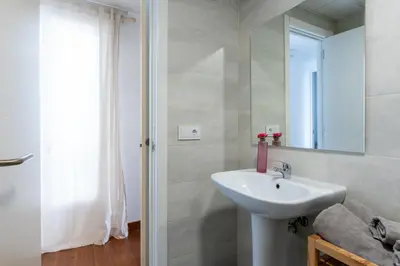 a bathroom with a sink and a mirror at Sanlúcar Olehousing in Sanlúcar de Barrameda