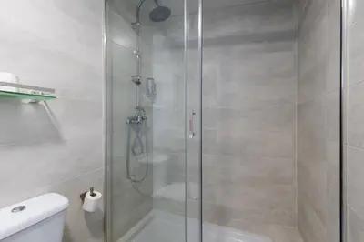 a shower with a glass door in a bathroom at Sanlúcar Olehousing in Sanlúcar de Barrameda