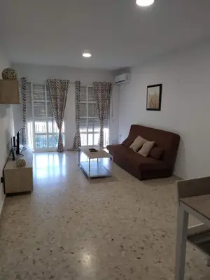 a living room with a couch and a coffee table at Luz y Sol San Fernando in San Fernando