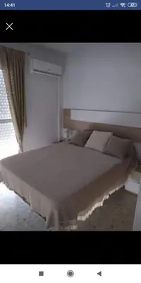a large bed in a room with a window at Luz y Sol San Fernando in San Fernando