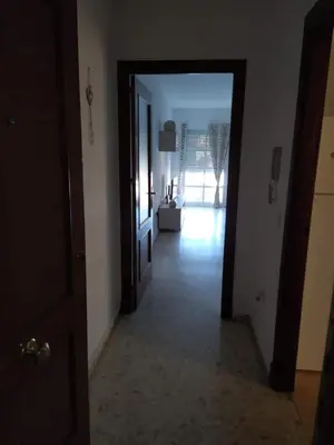 a hallway with a door leading to a living room at Luz y Sol San Fernando in San Fernando