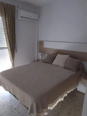 a bedroom with a large bed with a window at Luz y Sol San Fernando in San Fernando