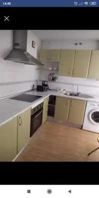 a kitchen with white cabinets and a stove top oven at Luz y Sol San Fernando in San Fernando