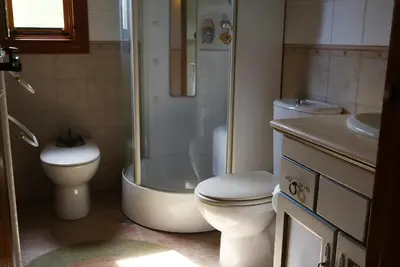 a bathroom with a shower and a toilet and a sink at Villa Ada con Piscina, Jardin y Parking 9,3 in Chiclana de la Frontera