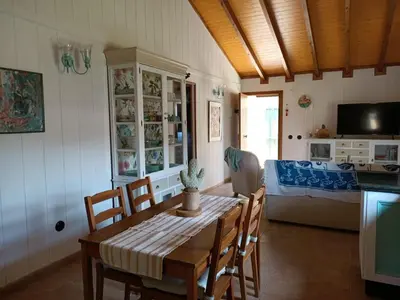 a kitchen and dining room with a table and chairs at Villa Ada con Piscina, Jardin y Parking 9,3 in Chiclana de la Frontera