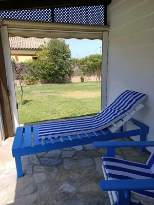 a blue bench sitting on the side of a house at Villa Ada con Piscina, Jardin y Parking 9,3 in Chiclana de la Frontera