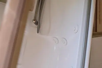a shower with two knobs on the side of a shower door at Villa Ada con Piscina, Jardin y Parking 9,3 in Chiclana de la Frontera