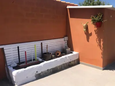 a corner of a building with plants on the side at Apartamento con Piscina ADULTS ONLY in Chiclana de la Frontera
