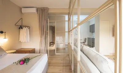 a room with a bed and a glass wall at Terraza Playa de Cádiz 1 Ha Apartment in Cádiz