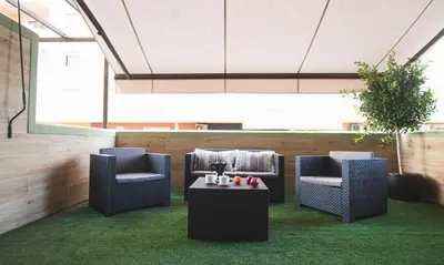 a lobby with two chairs and a table with candles at Terraza Playa de Cádiz 1 Ha Apartment in Cádiz