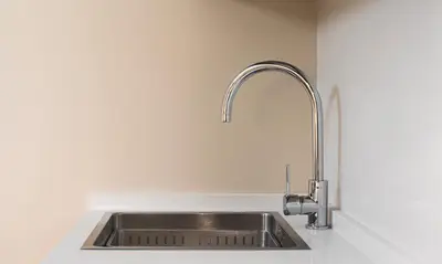 a stainless steel sink in a white kitchen at Terraza Playa de Cádiz 1 Ha Apartment in Cádiz