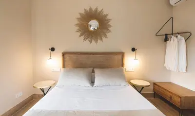 a bedroom with a bed and a mirror on the wall at Terraza Playa de Cádiz 1 Ha Apartment in Cádiz