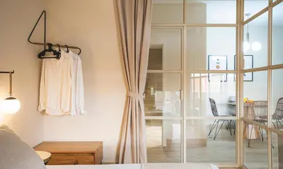 a bedroom with a sliding glass door and a living room at Terraza Playa de Cádiz 1 Ha Apartment in Cádiz