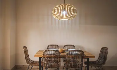 a dining room table with chairs and a chandelier at Terraza Playa de Cádiz 2 Ha Apartment in Cádiz