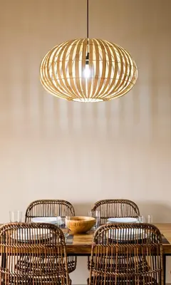 a dining room with a table with chairs and a light fixture at Terraza Playa de Cádiz 2 Ha Apartment in Cádiz
