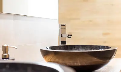 a bathroom with a wooden sink with a faucet at Terraza Playa de Cádiz 2 Ha Apartment in Cádiz