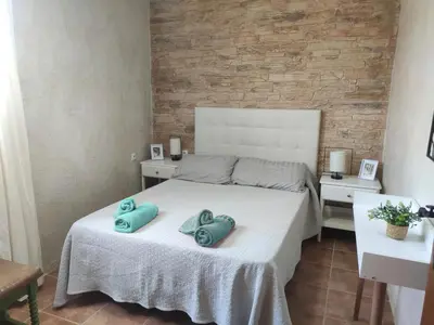 a bedroom with a bed with two pillows on it at Apartamento Fez playa de la barrosa in Chiclana de la Frontera