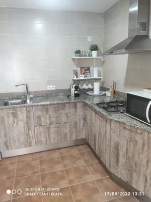 a kitchen with a sink and a stove top oven at Apartamento Fez playa de la barrosa in Chiclana de la Frontera