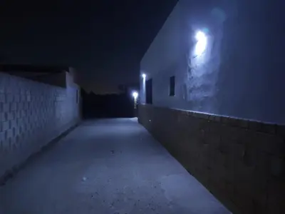 an empty alley at night with lights on the side of a building at Apartamento Fez playa de la barrosa in Chiclana de la Frontera