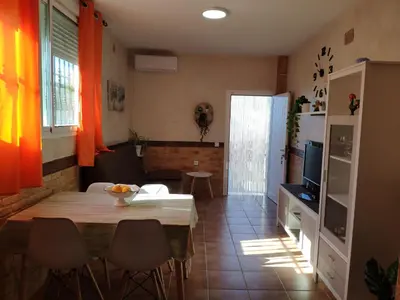 a kitchen and dining room with a table and chairs at Apartamento Fez playa de la barrosa in Chiclana de la Frontera
