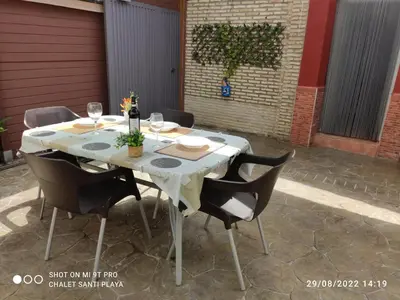 a white table with chairs and wine glasses on it at Apartamento Fez playa de la barrosa in Chiclana de la Frontera