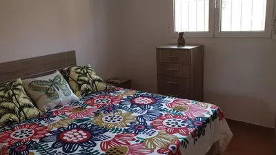 a bedroom with a bed with a colorful comforter at Apartamento Helena in Rota