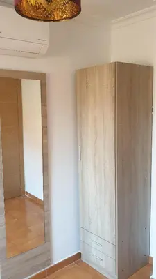 a room with a wardrobe and a mirror at Apartamento Helena in Rota