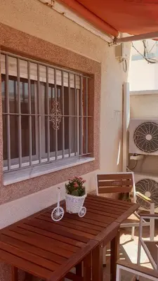 a wooden table with a potted plant on top of it at Apartamento Helena in Rota