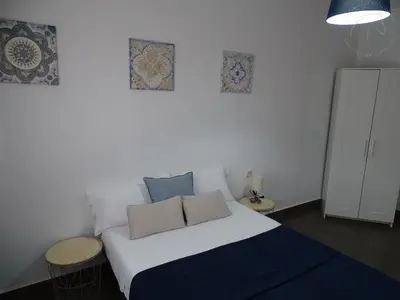 a bedroom with a white bed with two pillows on it at Casasjerezanas Vistaflor2 in Jerez de la Frontera