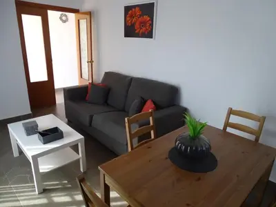 a living room with a couch and a table at Casasjerezanas Vistaflor2 in Jerez de la Frontera