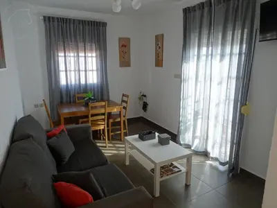 a living room with a couch and a table at Casasjerezanas Vistaflor2 in Jerez de la Frontera