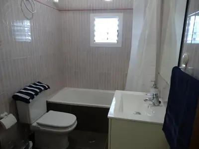 a bathroom with a toilet and a tub and a sink at Casasjerezanas Vistaflor2 in Jerez de la Frontera
