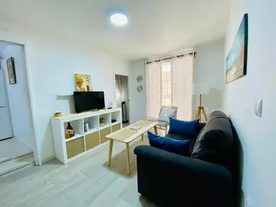 a living room with a couch and a tv at Playa y Sol Grupo AC Gestion in Cádiz