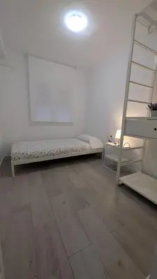 a room with a bed and a ladder at Playa y Sol Grupo AC Gestion in Cádiz