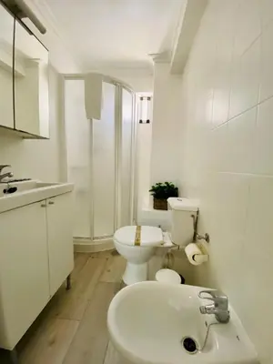 a white bathroom with a toilet and a sink at Playa y Sol Grupo AC Gestion in Cádiz