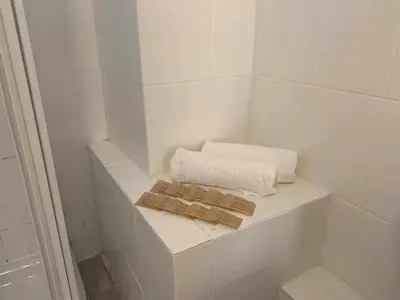 a small white bathroom with a towel and towels at Playa y Sol Grupo AC Gestion in Cádiz