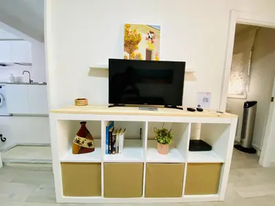 a white tv stand with a television on top at Playa y Sol Grupo AC Gestion in Cádiz