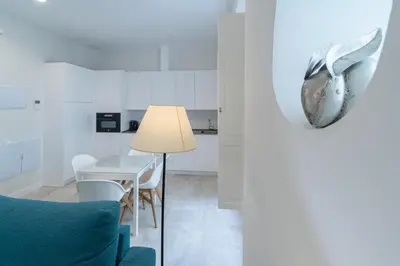 a living room with a blue couch and a table at Apartamento Cadiz Wonderland in Cádiz
