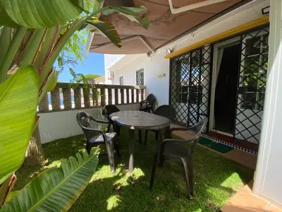 a patio with a table and chairs on a balcony at Apartamento Vip la Barrosa in Chiclana de la Frontera