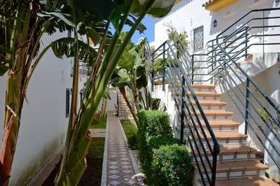 a stairway leading up to a building with plants at Apartamento Vip la Barrosa in Chiclana de la Frontera