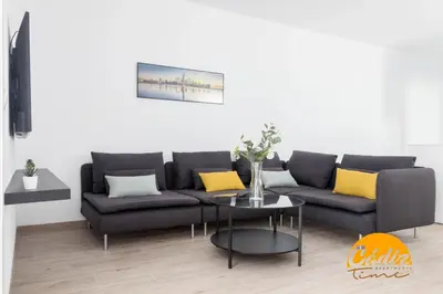 a living room with a couch and a table at Casa del Fotografo by Cadiz Time in Cádiz
