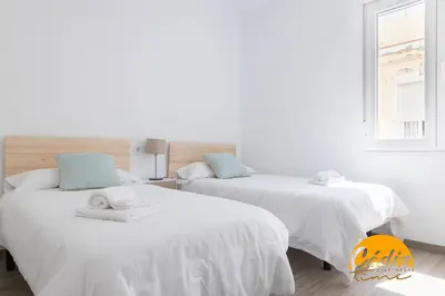 two white beds in a room with a window at Casa del Fotografo by Cadiz Time in Cádiz