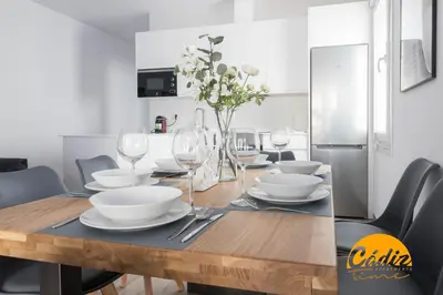 a dining room table with wine glasses and plates at Casa del Fotografo by Cadiz Time in Cádiz