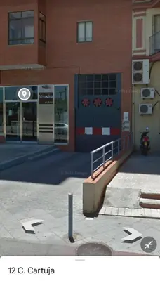 a building with a motorcycle parked in front of it at Sherryflat La Estación - Parking in Jerez de la Frontera