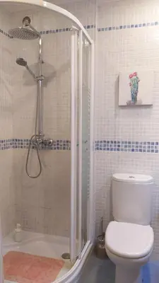 a bathroom with a shower with a toilet and a sink at Sherryflat La Estación - Parking in Jerez de la Frontera