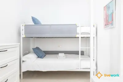 a white bunk bed in a white room at Apartamento Floral by LiveWork in Cádiz
