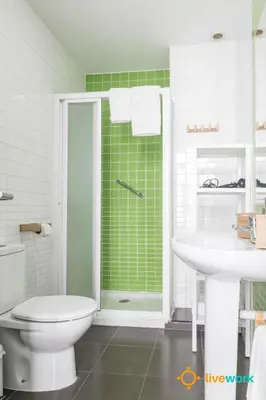 a bathroom with a toilet and a shower and a sink at Apartamento Floral by LiveWork in Cádiz