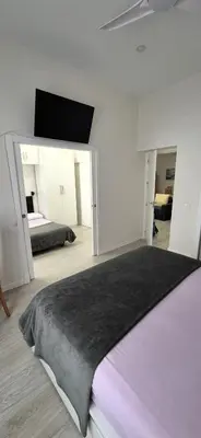 a bedroom with two beds and a black blanket at La esquina de los italianos by Gades Gestión in Cádiz